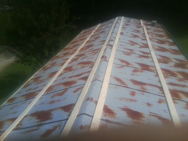 Rusted metal roof panels with new wood purlins before replacement — Storm Damage Roof Repair in Huntingburg by Roofing Brothers