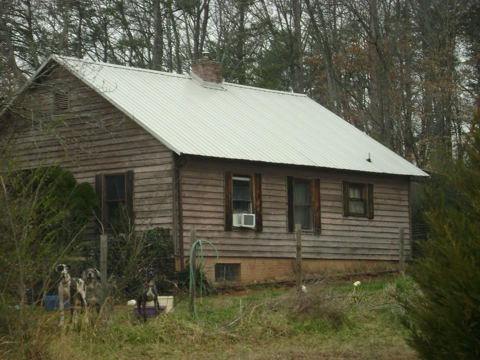 White metal roof on an old wood sided farmhouse, from a Metal Roof Installation job in Huntingburg